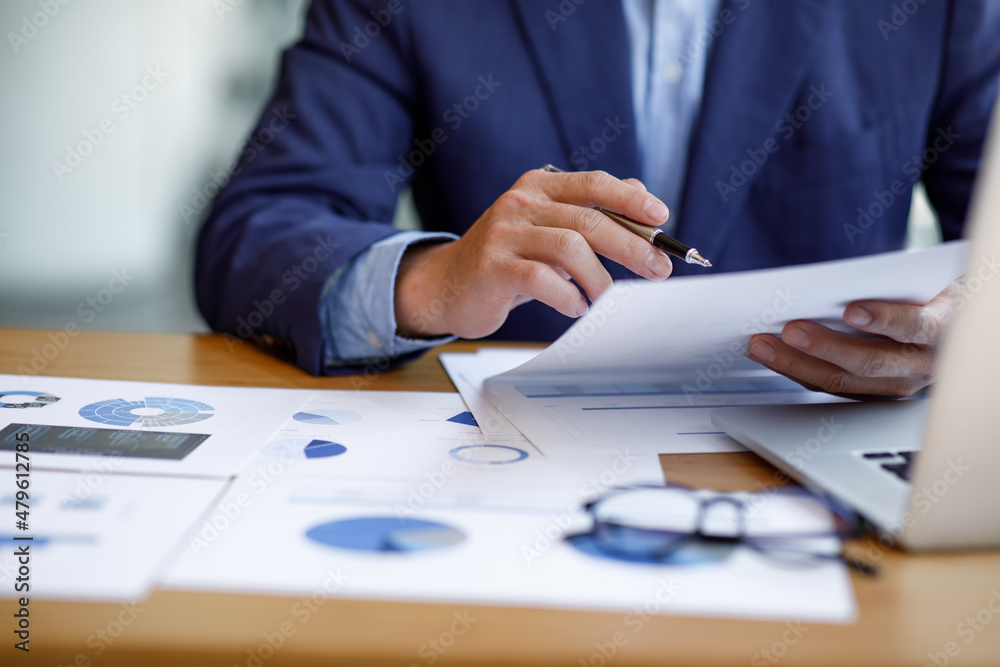 Businessman working at office with documents on his desk, doing planning analyzing the financial report, business plan investment, finance analysis concept Businessman working at office with documents on his desk, doing planning analyzing the financial report, business plan investment, finance analysis concept
