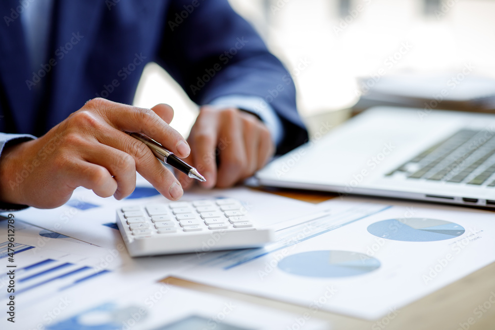Businessman working at office with documents on his desk, doing planning analyzing the financial report, business plan investment, finance analysis concept Businessman working at office with documents on his desk, doing planning analyzing the financial report, business plan investment, finance analysis concept