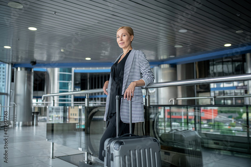 Businesswoman with the baggage posing for the camera