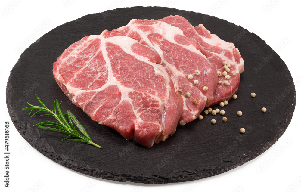 raw pork meat with rosemar and peppercorn on black round stone plate isolated on white background. Clipping path and full depth of field raw pork meat with rosemar and peppercorn on black round stone plate isolated on white background. Clipping path and full depth of field