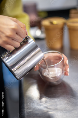 Close up picture of a womans hands pouring cocoa into the glass