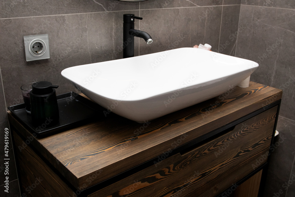 Fototapeta premium Modern bathroom with wooden table under the sink