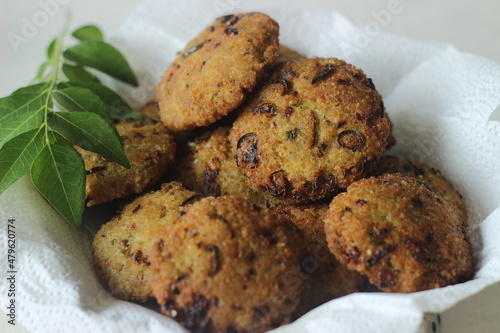 Kodo millet fritters. A crispy fritters made with cooked and mashed kodo millet flour and spices. Disk shaped deep fried evening snack. Commonly known as Kodo millet vada photo