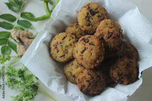 Kodo millet fritters. A crispy fritters made with cooked and mashed kodo millet flour and spices. Disk shaped deep fried evening snack. Commonly known as Kodo millet vada photo