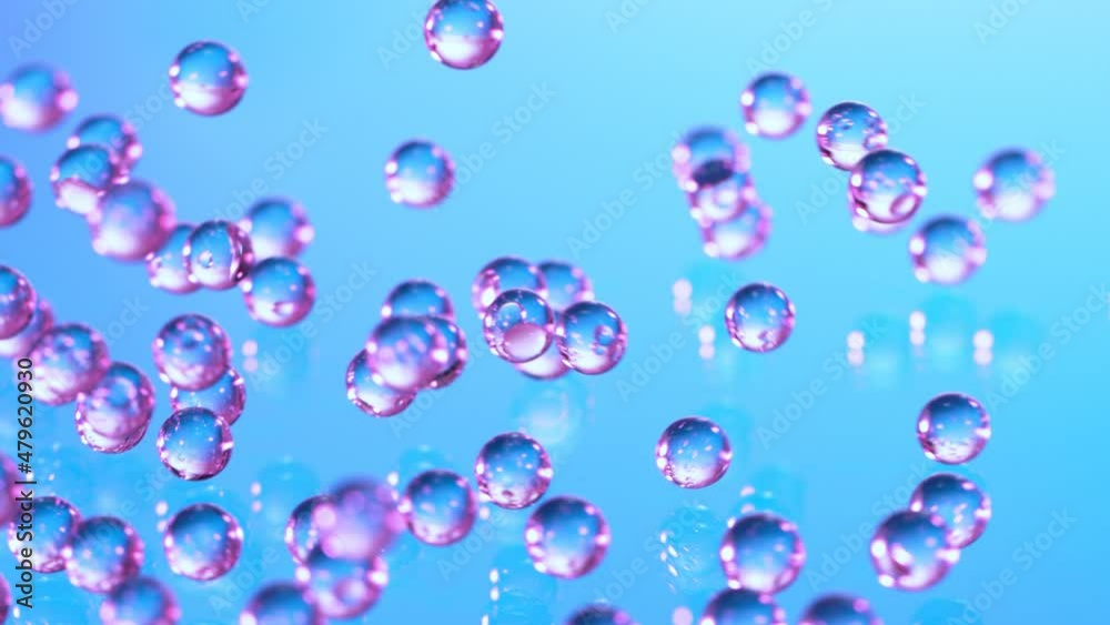 Super Slow motion Shot of Neon Hydrogel Balls Bouncing on Glass at 1000fps.