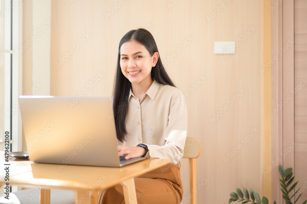 Young business woman working with her laptop in coffee shop Young business woman working with her laptop in coffee shop