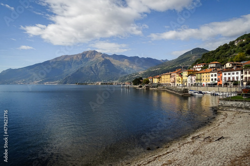 Lake como , bay of Domaso, Italy, typical houses of the village with mountains in background andy blue sky