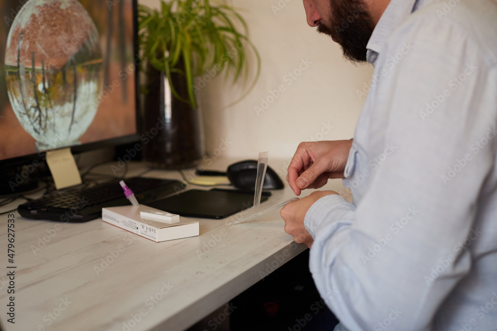 Anonymous man preparing for a rapid covid test Anonymous man preparing for a rapid covid test