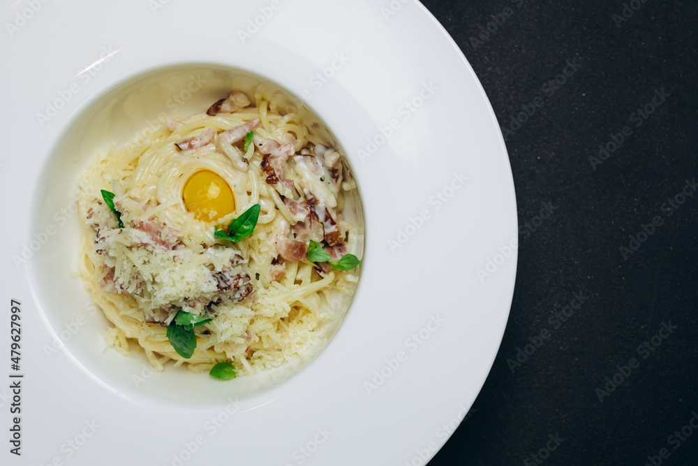 We can see a new dish that includes fried egg and spaghetti. We can see a new dish that includes fried egg and spaghetti.