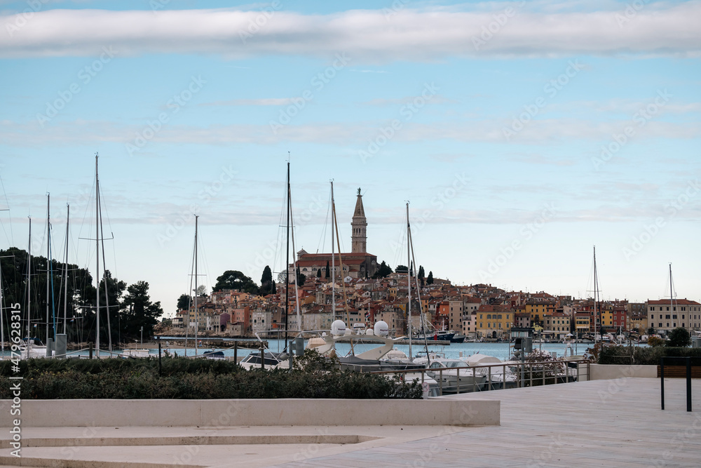 Beautiful town of Rovinj and its famous church Saint Euphemia with recognizable tower high above the houses, photographed from the Mulini beach