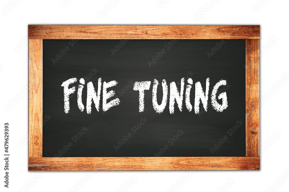 FINE TUNING text written on wooden frame school blackboard. FINE TUNING text written on wooden frame school blackboard.