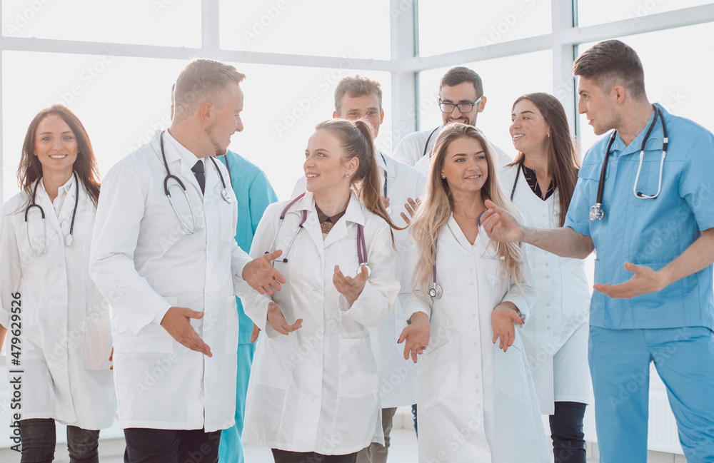 doctors of the medical center discussing important issues in the hospital corridor. doctors of the medical center discussing important issues in the hospital corridor.
