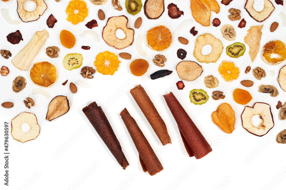 Close up of well laid out different dried fruits kiwi, apples, orange, persimmon and nuts on white background. Concept of natural fruit lozenge with different colors. Close up of well laid out different dried fruits kiwi, apples, orange, persimmon and nuts on white background. Concept of natural fruit lozenge with different colors.