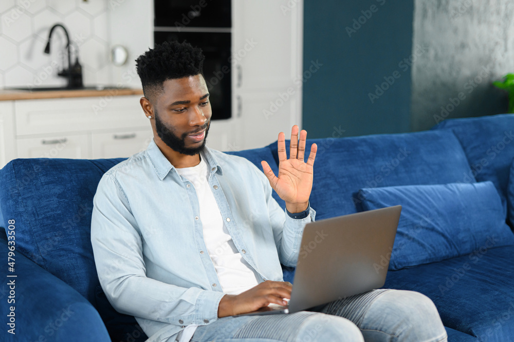African American Man working from home with laptop and phone African American Man working from home with laptop and phone