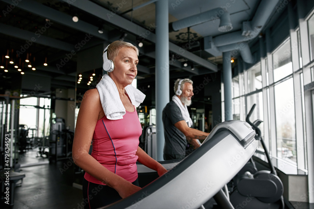 Attractive mature woman exercising in gym Attractive mature woman exercising in gym