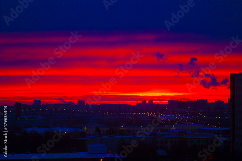 Bright red dawn in the morning of a huge industrial metropolis
