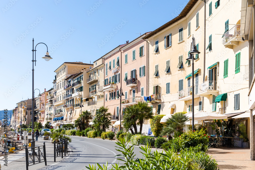Row of houses on the harbor of the islandCapital Portoferraio on the island of Elba in Italy under a bright blue sky in summer