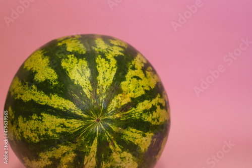 Watermelon close up against pink background with copy space photo