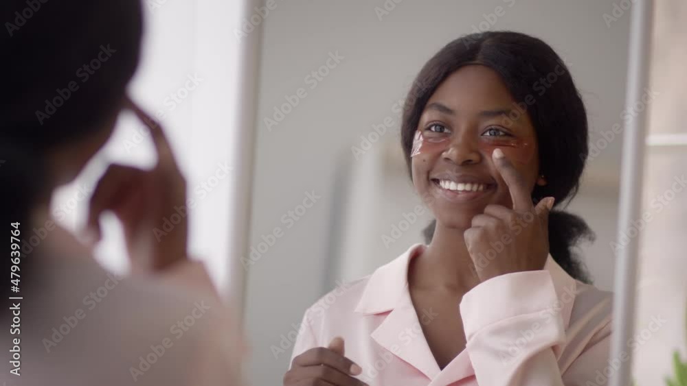 Happy African American Lady Applying Patches Under Eyes At Home Happy African American Lady Applying Patches Under Eyes At Home