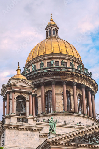 bottom view of the gilded dome and colonnade of St. Isaac's Cathedral against the background of the blue sky. Saint Petersburg. Russia
