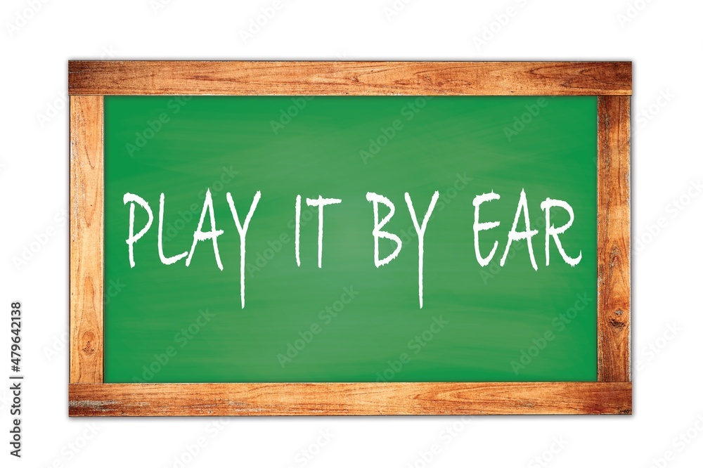 PLAY  IT  BY  EAR text written on green school board.