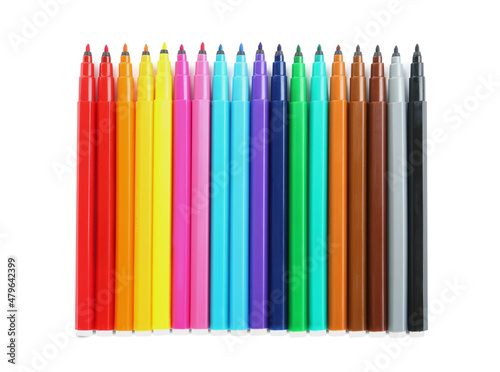 Many colorful markers on white background, top view. School stationery