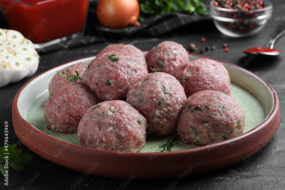 Many fresh raw meatballs on black table Many fresh raw meatballs on black table
