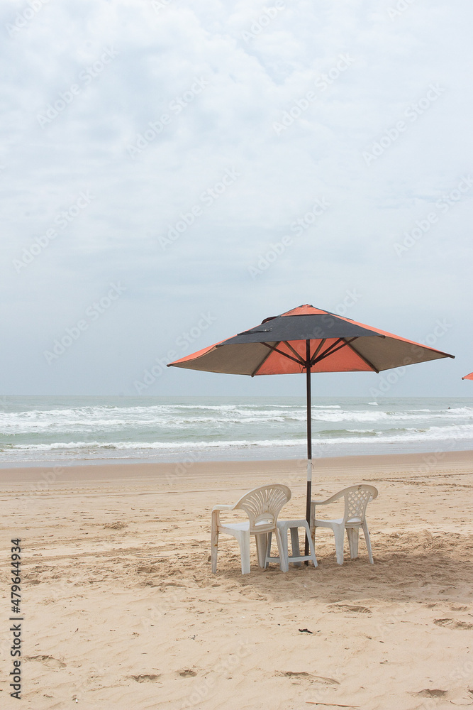 beautiful landscape with beach chair and a parasol on a sunny day.
