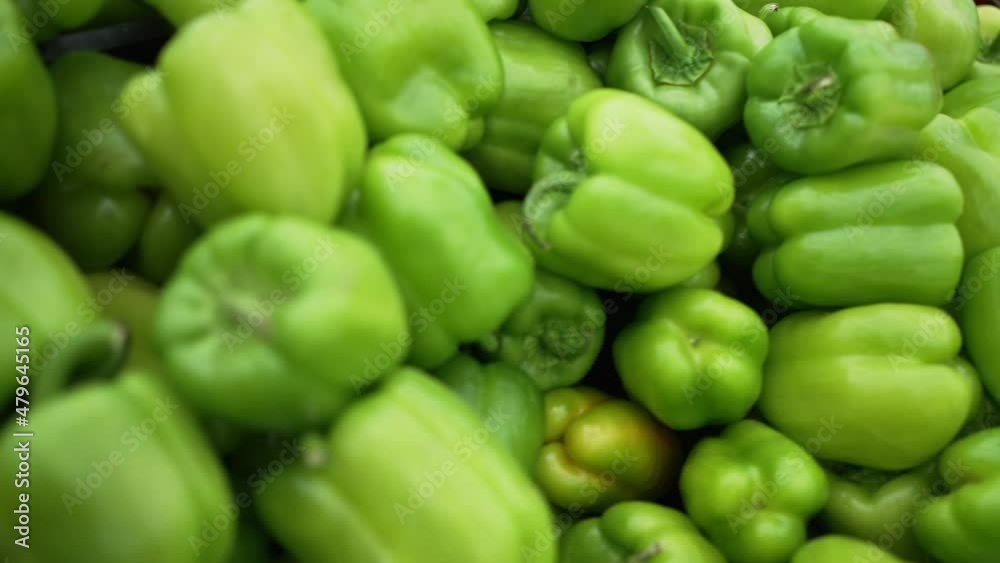 Fresh and bright multi-colored bell and chili peppers lying in different containers in supermarket at artificial illumination close view Fresh and bright multi-colored bell and chili peppers lying in different containers in supermarket at artificial illumination close view