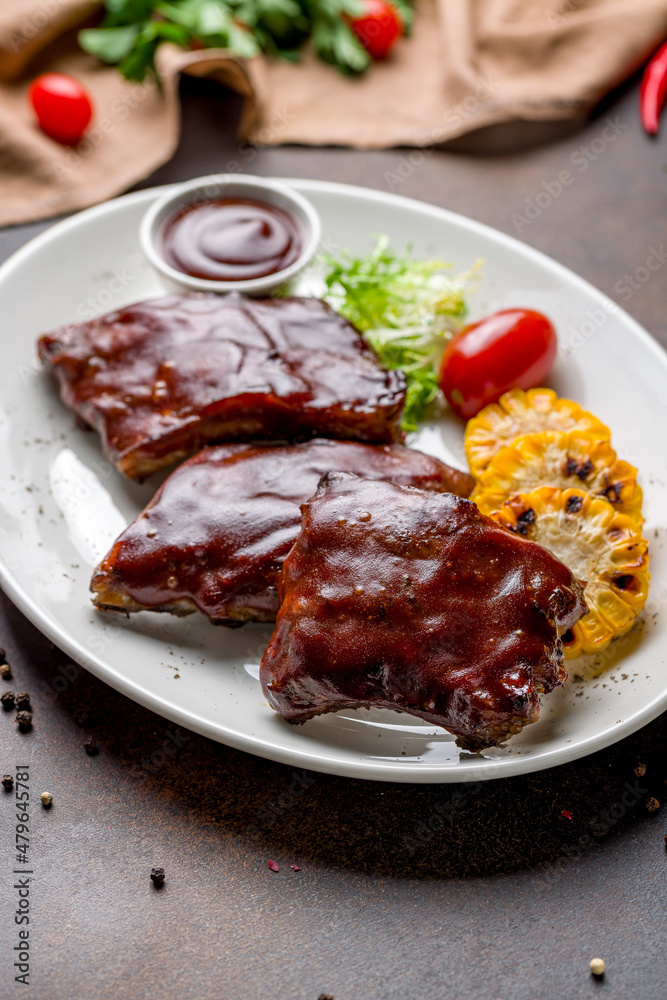 Barbecue pork ribs on dark brown concrete table side view Barbecue pork ribs on dark brown concrete table side view