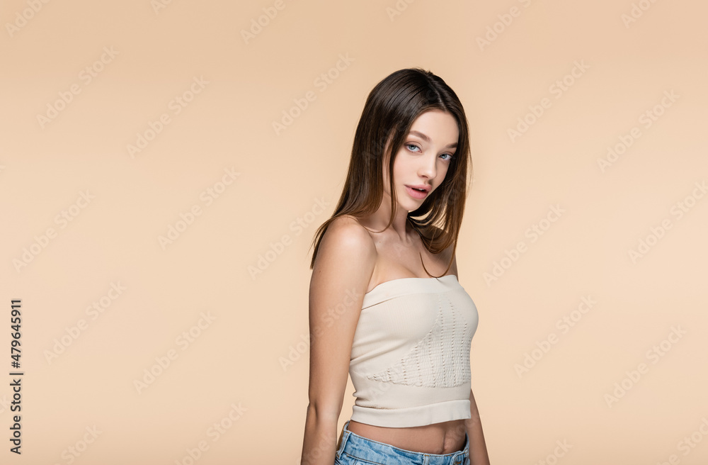 brunette and pretty woman in crop top with bare shoulders isolated on beige brunette and pretty woman in crop top with bare shoulders isolated on beige