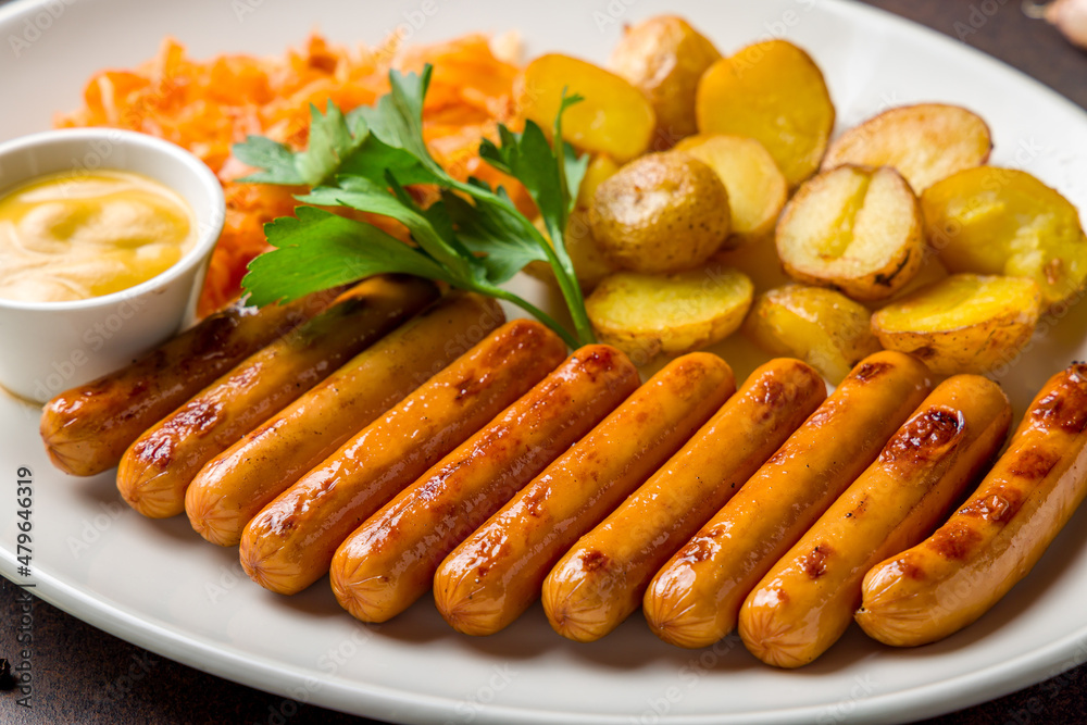 fried viennese sausages with fried cabbage and potatoes on white plate macro close up fried viennese sausages with fried cabbage and potatoes on white plate macro close up