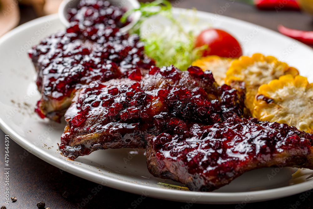 fried pork ribs with lingonberry sauce macro close up fried pork ribs with lingonberry sauce macro close up