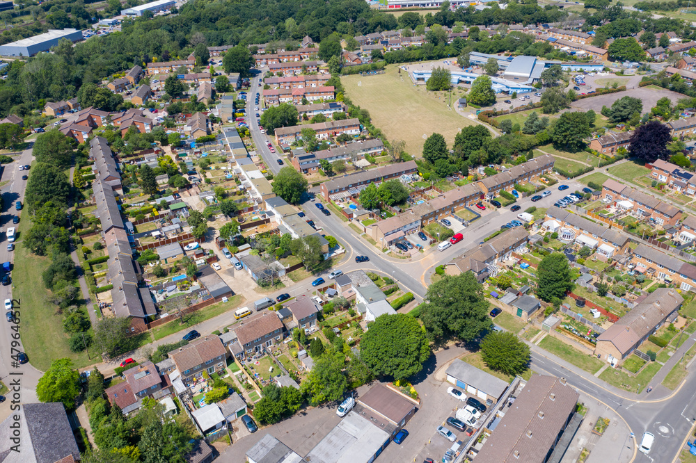 Aerial photo of the British town of Stevenage in Hertfordshire UK showing a typical British housing estate with rows of houses in the village, on a hot sunny summers day.
