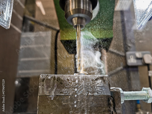 Smoke and drops from coolant liquid on a drill