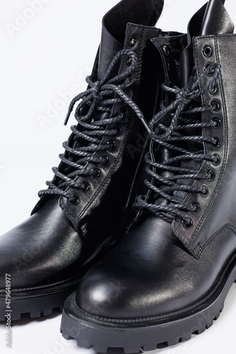 Black women's leather lace-up boots from the new collection on a white background from leather autumn-winter 2022. Boots close-up