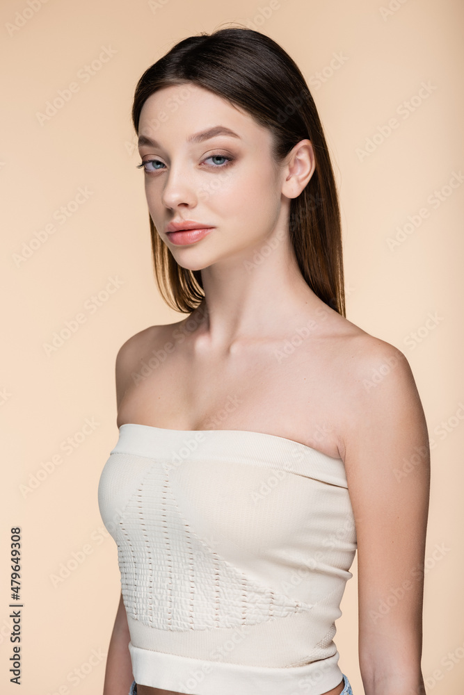 confident woman in crop top with bare shoulders isolated on beige confident woman in crop top with bare shoulders isolated on beige