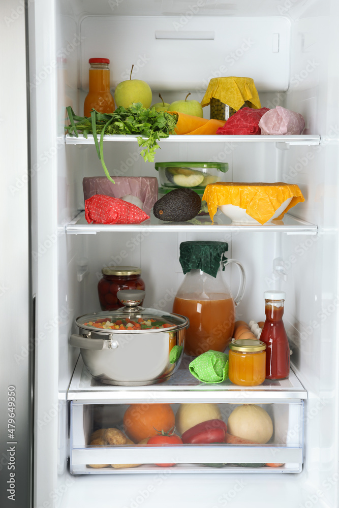 Open refrigerator with many different products packed in beeswax food wraps Open refrigerator with many different products packed in beeswax food wraps