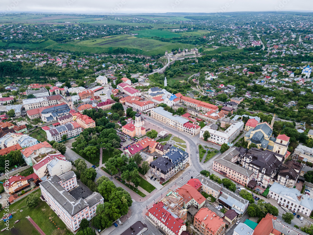 Picturesque landscape with Old Town of Kamianets-Podilsk. Ancient city with high tower of town-hall and mighty fortress on background, aerial summer view. 