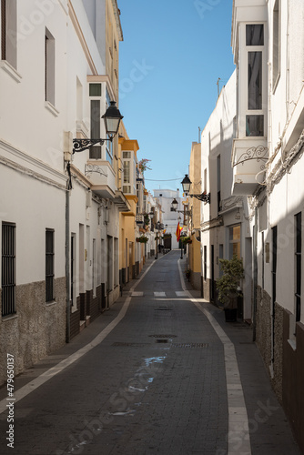 A narrow street with rows of white houses on the sides, Rota, Cadiz, Andalusia, Spain