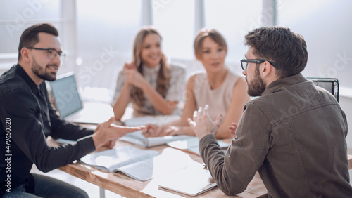 Photography business partners hold a dispute at a meeting in the office