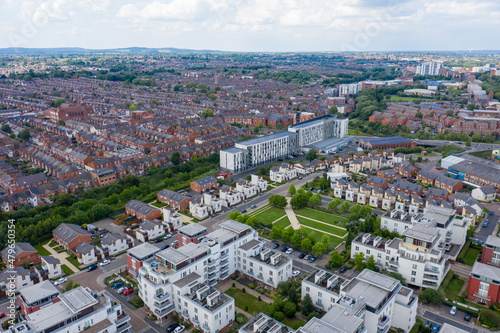 Aerial photo of the city centre of Leicester in the UK showing houses and apartment building on a sunny summers day with white clouds in the sky photo