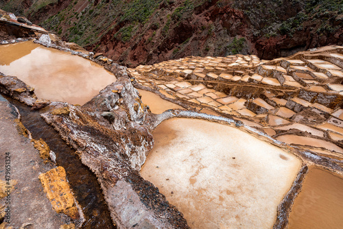 Minas de Sal de Maras, the salt mines in Maras, Cusco, Peru, where pink mineral salt is harvested in over 4000 pools owned by local residents only. photo