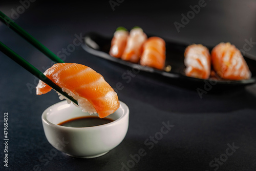 Fotografie Salmon onigiri on chopsticks.