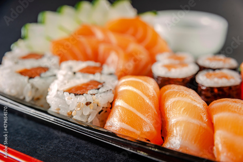 Salmon onigiri with salmon onigiri varieties on a delivery tray. Closeup.
