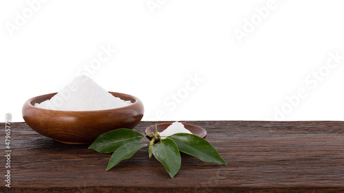 Camphor crystal and green leaves on wood table isolated white background with clipping path.