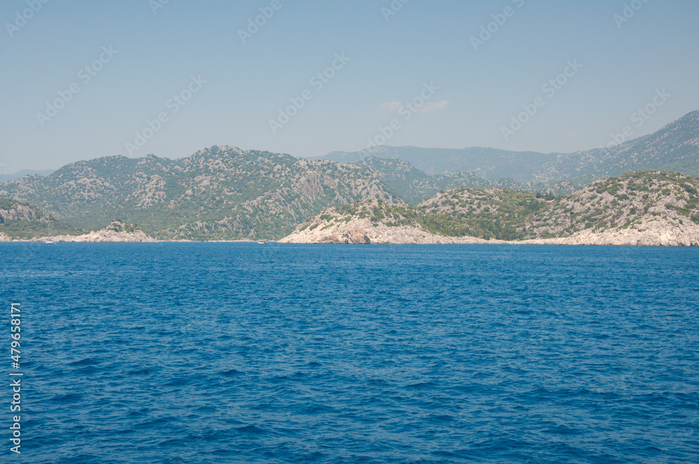 Blue sea and mountain under sky. Landscape background on sunny afternoon