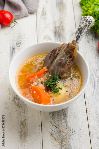 Khashlama with lamb on white wooden table, vertical photo