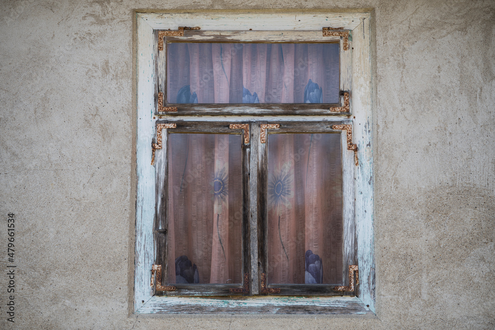 Sunja, Croatia, 05,04,2021: Rustic style aged window in wooden village rural home wall.