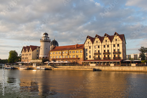 The Fishing Village and lighthouse on the banks of Pregolya River at sunset light, Kaliningrad, Russia